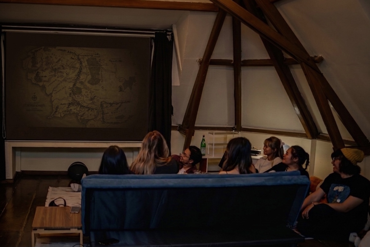 Friends watching a film on the loft's A-frame cinema screen