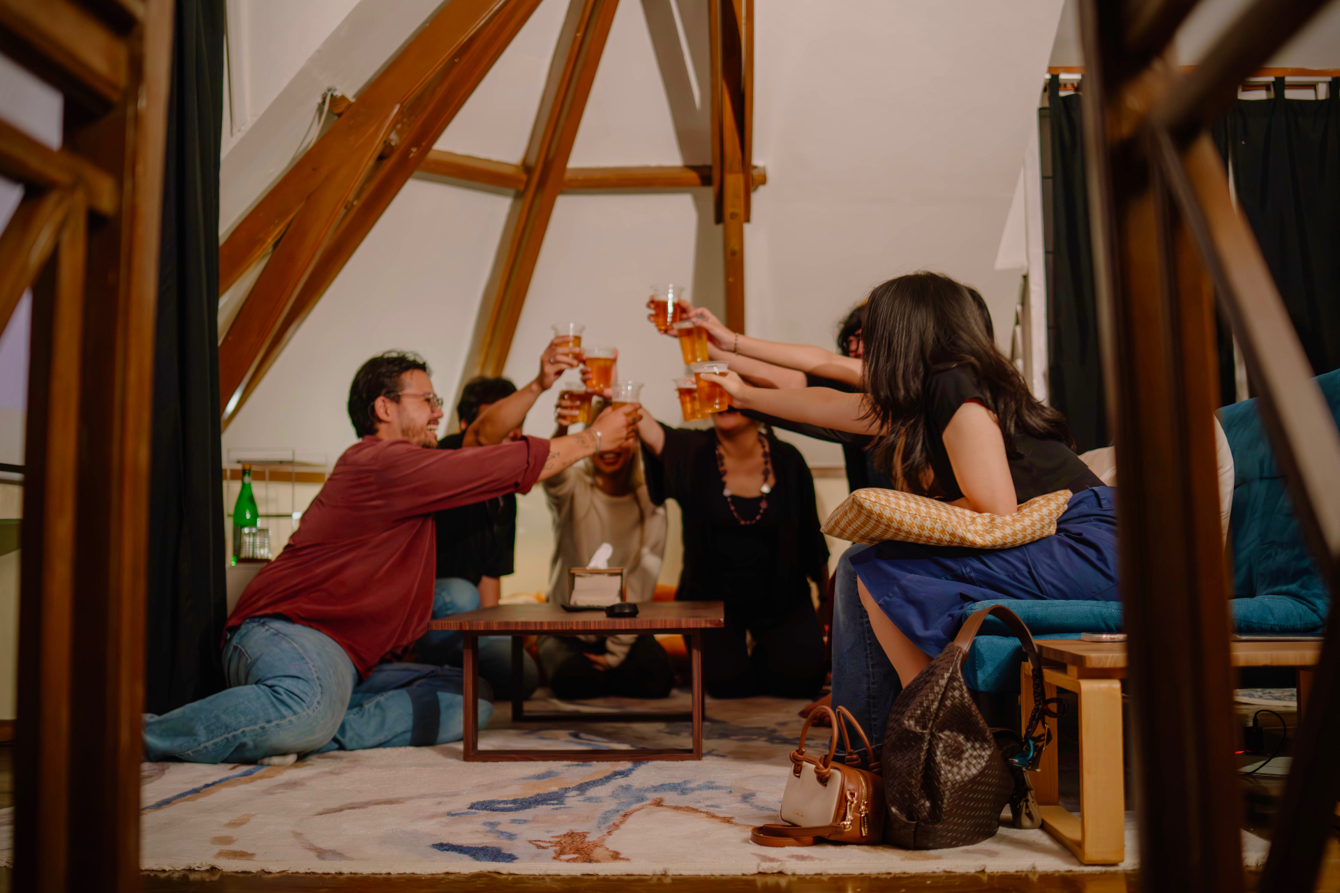 Friends raising a toast under the loft's timber A-frame