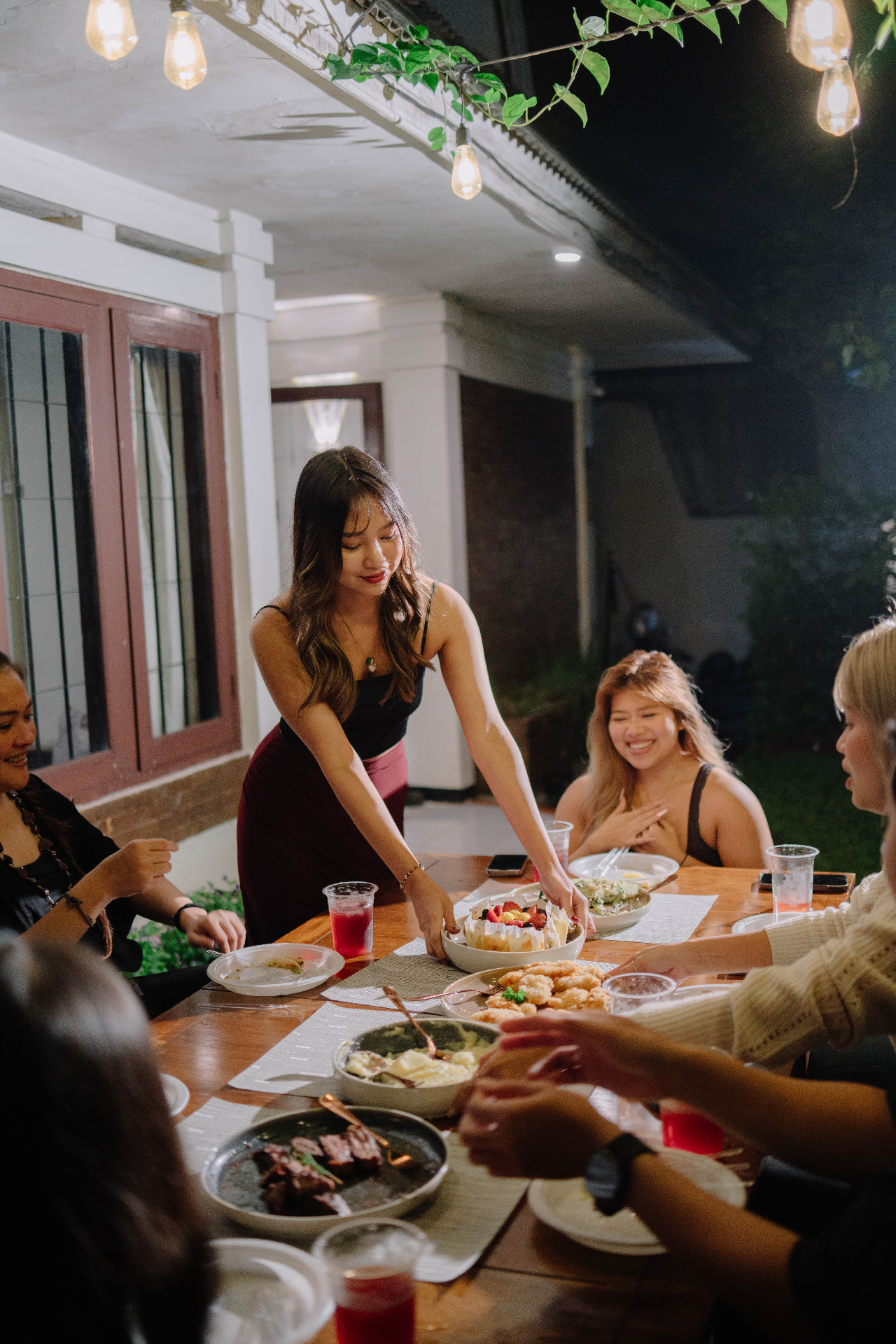String-light dinner gathering in the backyard